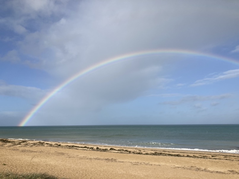 Un arc en ciel au dessus de la mer, vu depuis une plage du Calvados